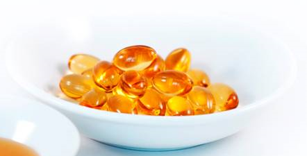 A bowl of fish oil on top of the table.