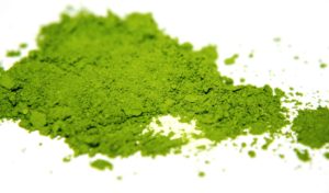 A close up of some green powder on top of a table