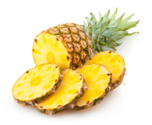 A pineapple cut in half and sliced into quarters.