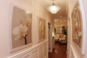 A hallway with white walls and wooden floors.