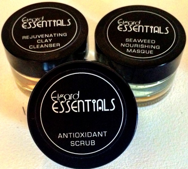 Three jars of facial products are shown on a table.