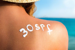 A woman with sunscreen on her back.