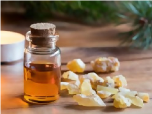 A bottle of oil and some rocks on the table